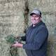 Anthony Smith is all smiles with a sample of the winning best looking lucerne hay he and his family grew at Bedgerabong. Photo: Melissa Smith
