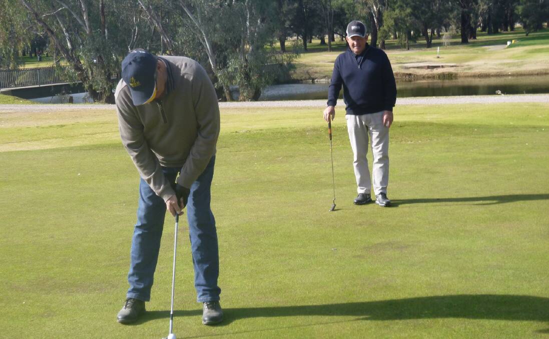 Pairing Up: Greg Webb concentrating on his putt while Brian Doyle watches closely.
