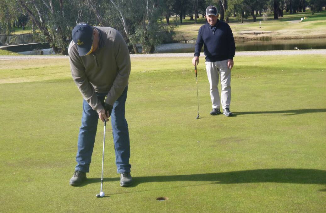 Forbes Fabulous Golf: Greg Webb concentrating on his putt while Brian Doyle watches closely. (The Advocate apologises for the incorrect caption on Friday).