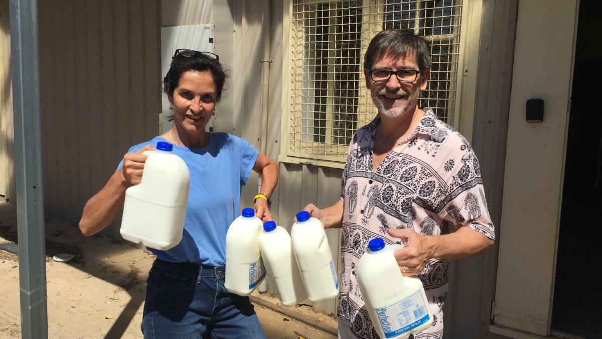 PITCHING IN: Angela and Graham Sattler brought in litres of milk on Sunday.