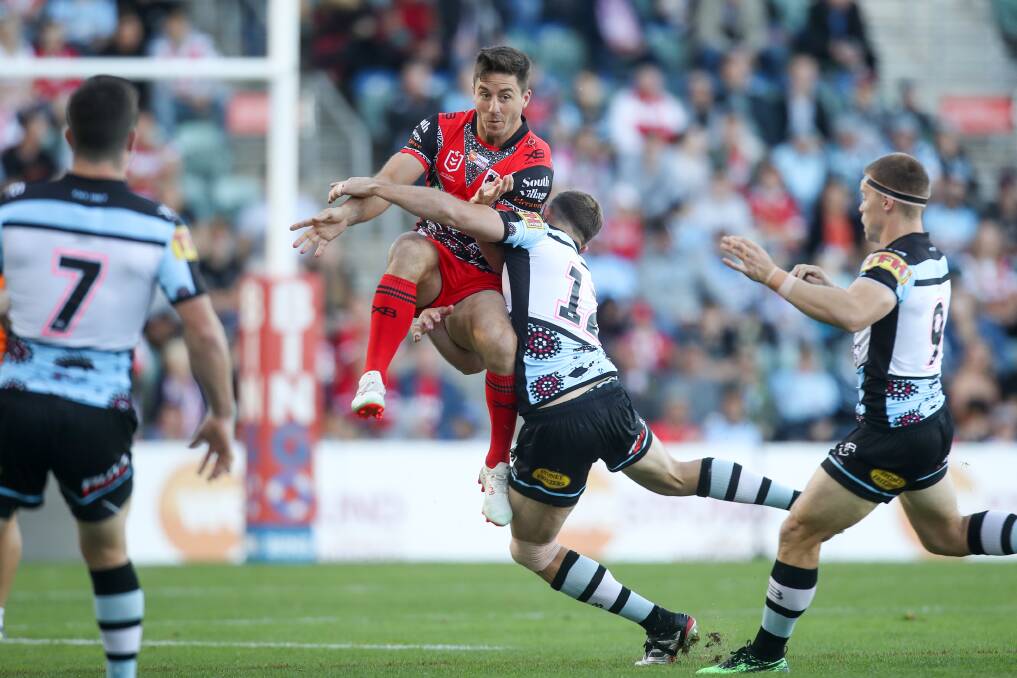 UNDER PRESSURE: Dragons five-eighth Ben Hunt is tackled by a Sharks defender during a game at WIN Stadium last year. Picture: Adam McLean