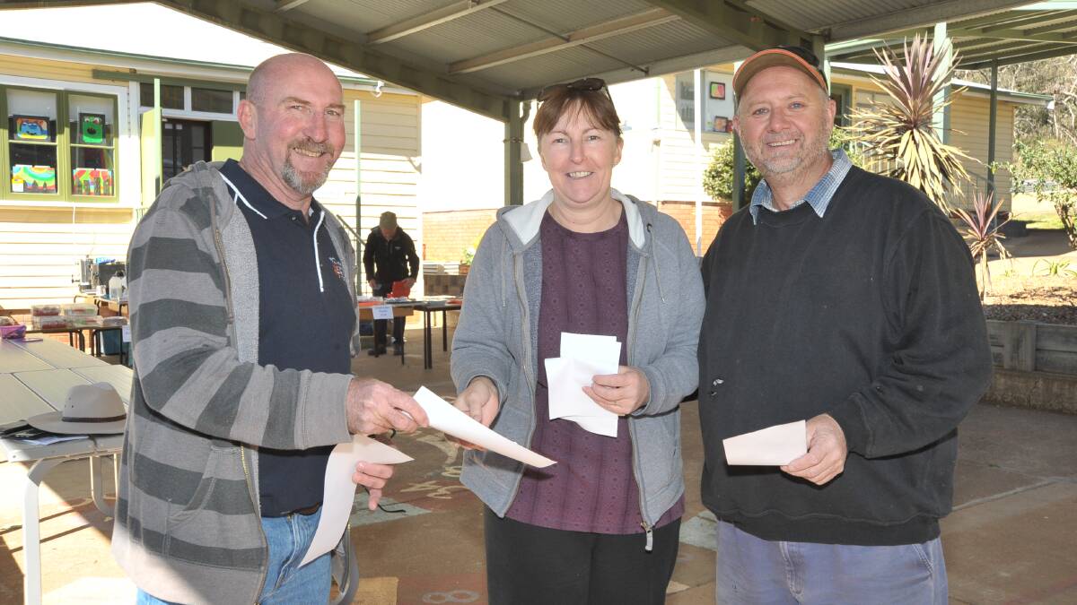 SHORT RACE: Candidate Greg Treavors hands Jan and Darren Frecklington how-to-vote material at Nashdale on Saturday. Photo: JUDE KEOGH 0909jkcabelect5