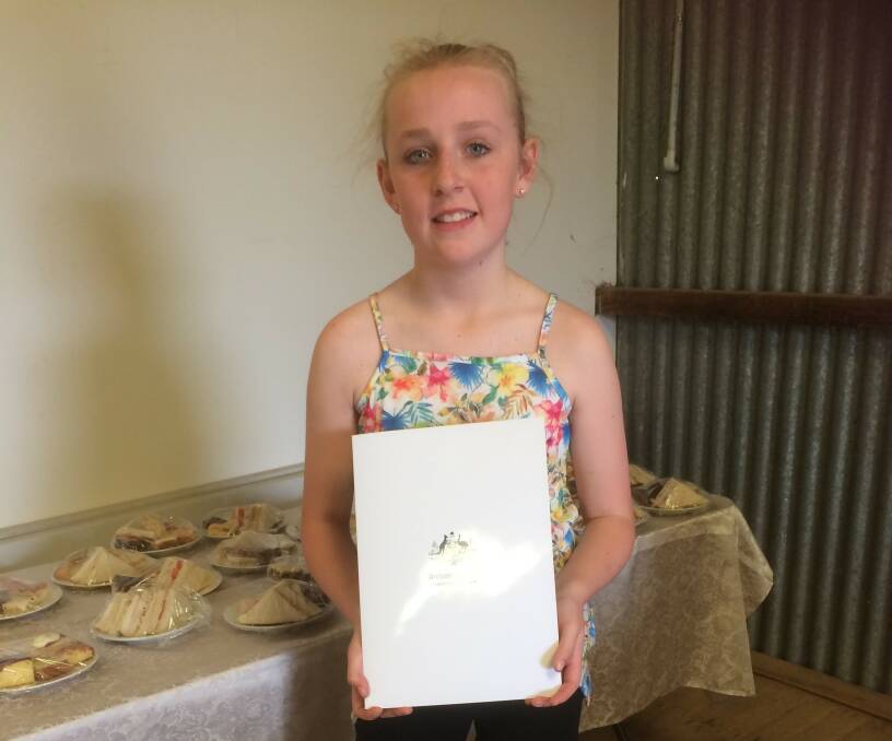 Eugowra CWA Junior member Sophie Noble who had been assisting with the catering at Eugowra Show, holding certificate from Federal Parliament.