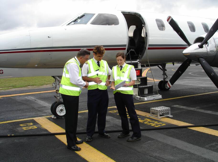 CASA Flying Operations Inspector with pilots. File photo by CASA.