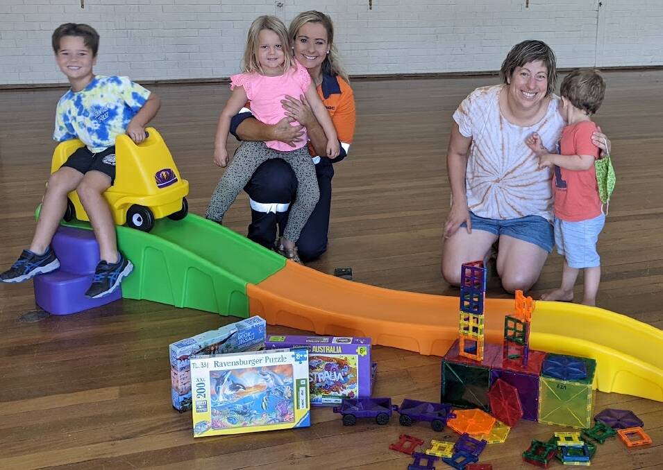 Enjoying the new Up and Down Roller Coaster, jigsaw puzzles and magnetic bricks at Forbes Toy Library recently were Northparkes Community and External Relations Advisor Gabe Albert (centre) with her children Ashton and Everleigh, and Toy Library Grants Officer Linda Carne with her son Ollie.