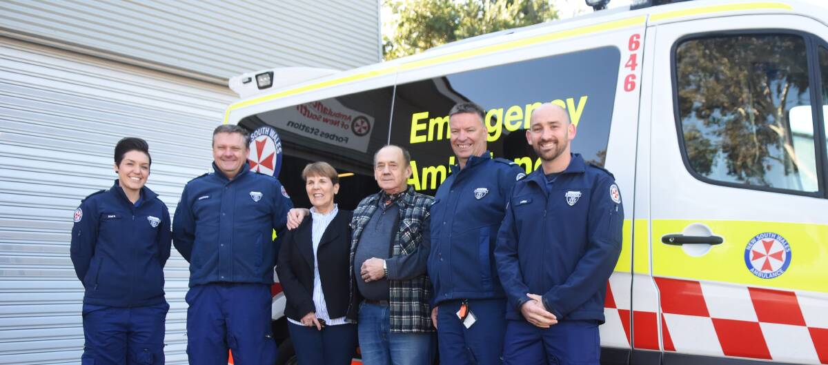 Lionel Hugget and his wife Dianne with ambulance officers Kara West, Matthew White, Kevin Watts and Luke Randall.