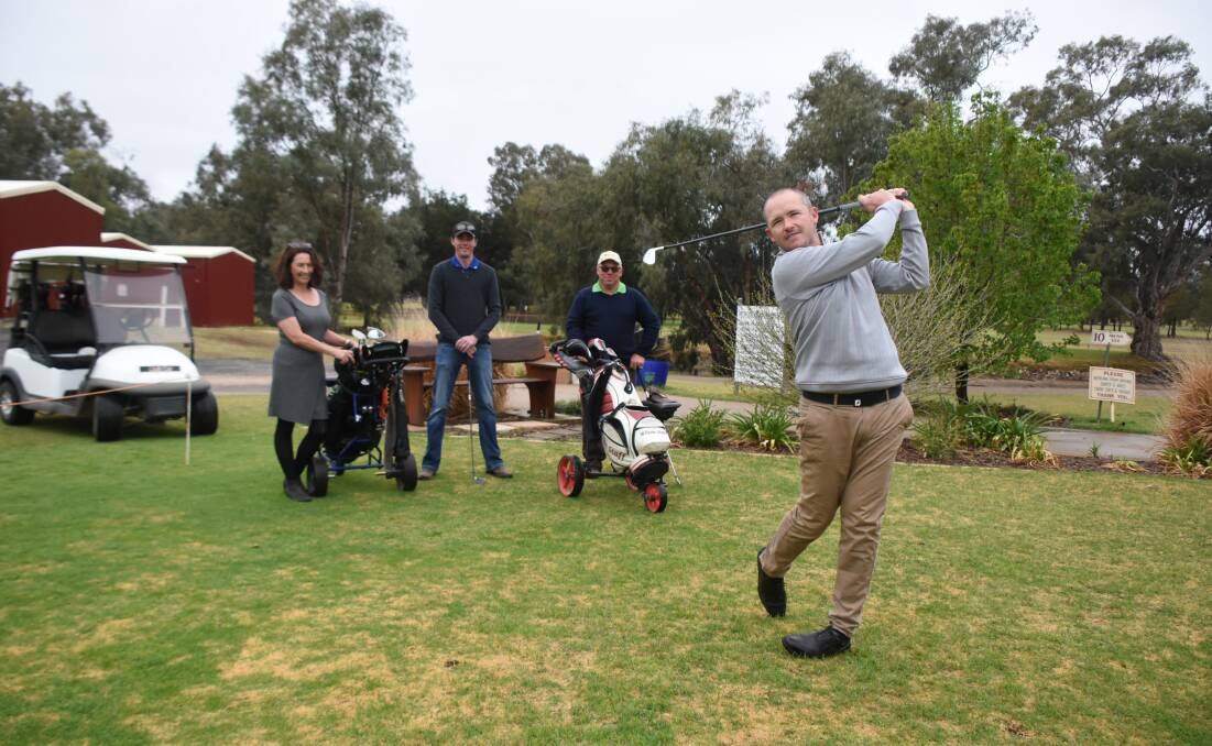 Forbes golf professional Ben Gear tees off as Forbes Deputy Mayor Jenny Webb, Andrew Cogswell (Lachlan Commodities) and Andrew Dukes (Tournament Director) look on. 