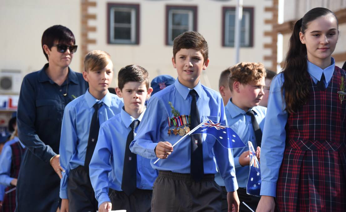 Students march through Forbes on Anzac Day, 2018.