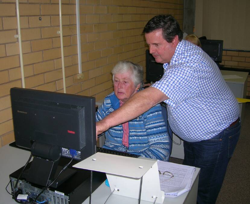 Joan Day with teacher Steve learning how to Google search, look up weather forecasts and other items of interest.