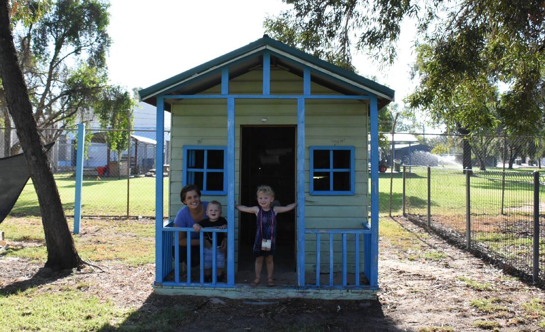 Beth, Max and Molly Betland from Forbes Playgroup enjoying the playgroup's cubby house and celebrating the announcement of funding for a bike track for the Youth and Community Centre.