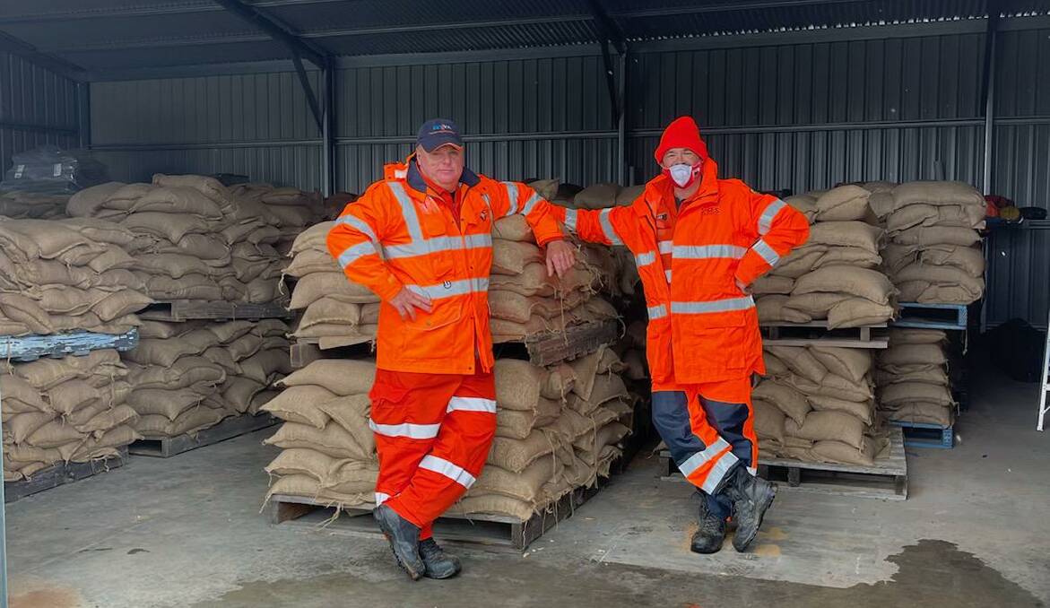 SES volunteers Matt Ando and Chris Hodge ready to load sandbags on Saturday.
