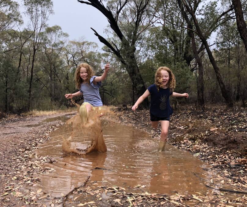 Boots and all: Isabelle and Breanna Powell enjoying the novelty of the puddles and hoping to see more in coming weeks and months.