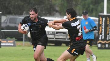 Eagles captain coach Alex McMillan slips away from the Grenfell defence in early rain in Sunday's season opener. 