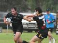 Eagles captain coach Alex McMillan slips away from the Grenfell defence in early rain in Sunday's season opener. 