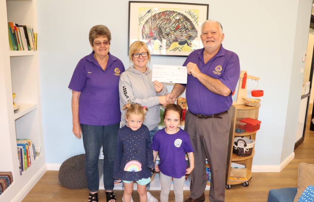 Peter and Elaine Bright present the cheque to Forbes Pre School director Amy Shine, while Frankie Hurford and Zola King give their approval. 