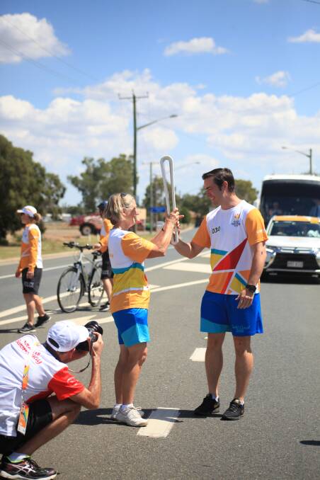 Robin Lyell receives the baton from James Smart in Forbes. 