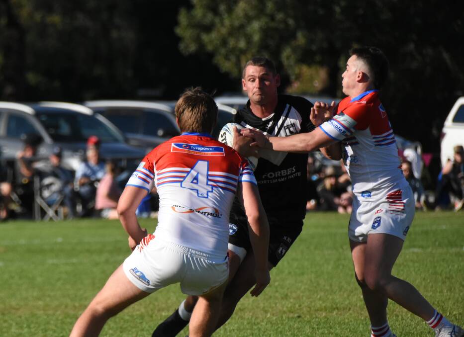 BATTLE: Forbes Magpies' Jake Grace met by Mudgee Dragons defence when the two teams met at Forbes in the opening round of the Peter McDonald Premiership. 