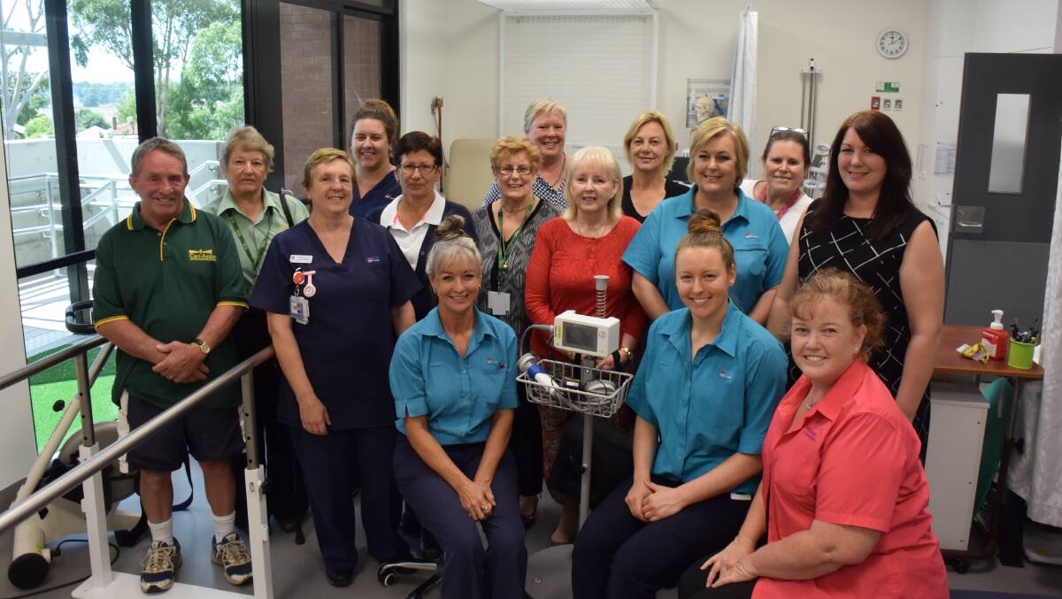 Happy representatives of the fundraising bodies with Forbes Health Service staff and the PhysioTouch machine. 