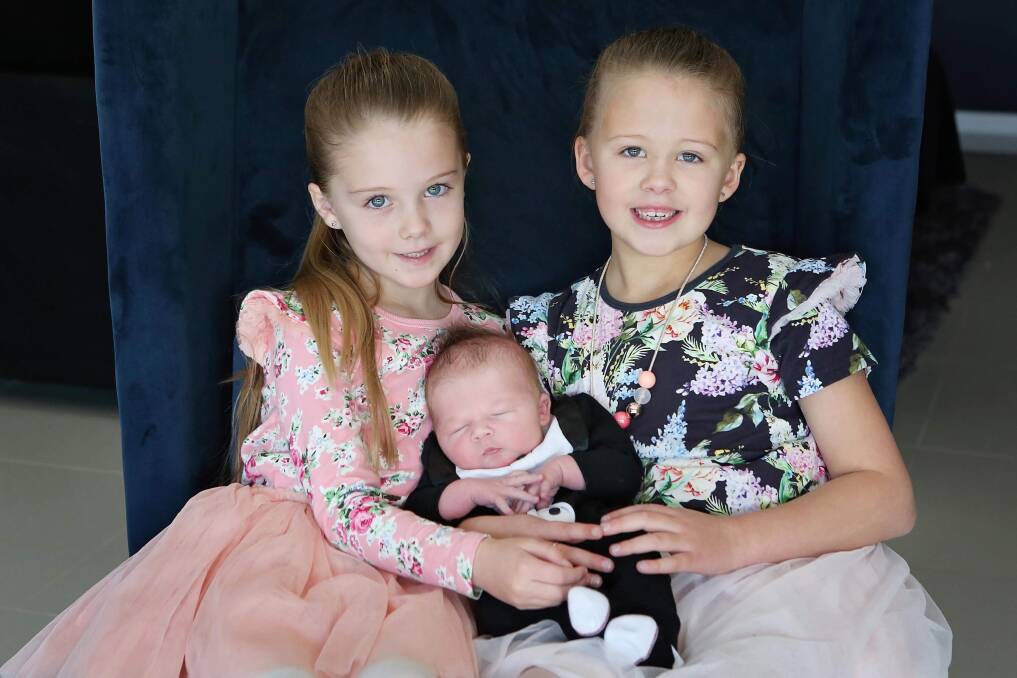 Ella and Ivy Stibbard with baby brother Jock. 
