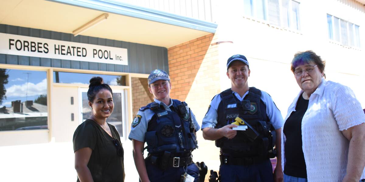 Heated pool committee members Kaushulya Brown and Dianne Decker hand a heated pool key over to Constable Natalie Rolfe and Senior Constable Ben Herden. 