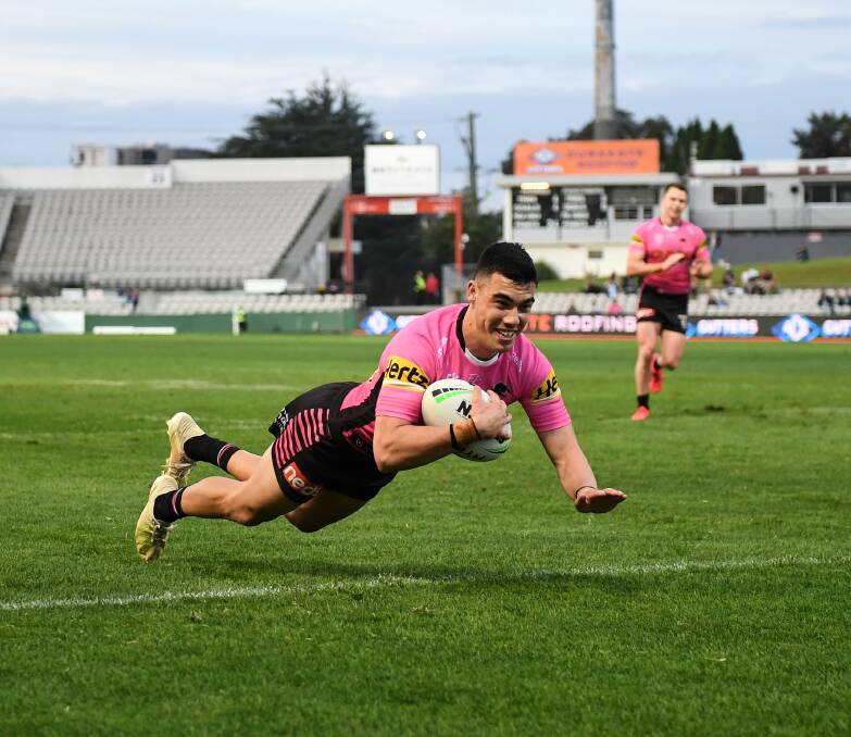 ALL SMILES: Charlie Staines flies in to score one of his four tries on debut on Saturday. Photo: NRL PHOTOS