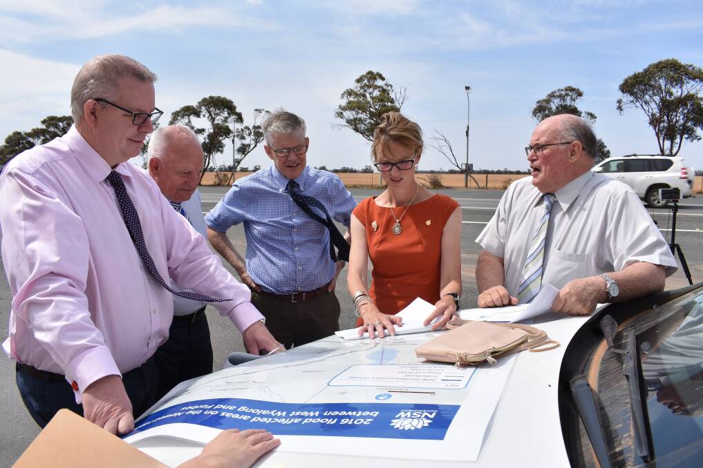 Alistair Lunn, Director Western Region, RMS, Ray Smith, General Manager Bland Shire, Cr Brian Monaghan, Mayor Bland Shire, Steph Cooke MP, Member for Cootamundra and Cr Tony Lord, Bland Shire looking at the map of flooding locations between Forbes and West Wyalong.