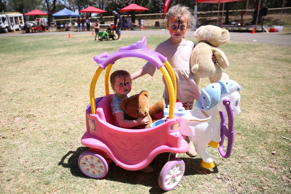 Isabelle and Olivia Cooper taking their teddy bears for a ride in the princess chariot at the picnic event in 2019.