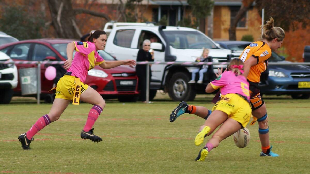 Geagles in Pink: Ashlee Newell and Mikaylah Dukes in pursuit of a Canowindra player. The Geagles league tag team wore pink jumpers for Breast Cancer Awareness Day and had a runaway win over the Canowindra girls.