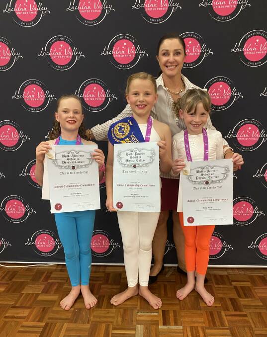 Louise Donnelly congratulates Lachlan's Aleigha Hornery, Molly Betland and Charlotte Miller who took out second, Zone Champion and third places at Zone. Picture supplied
