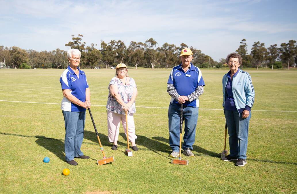Marie Spry, Cheryl Toohey, Merv Langfield and Lorraine Todd enjoying their game of croquet on what seems like a rare sunny morning. 