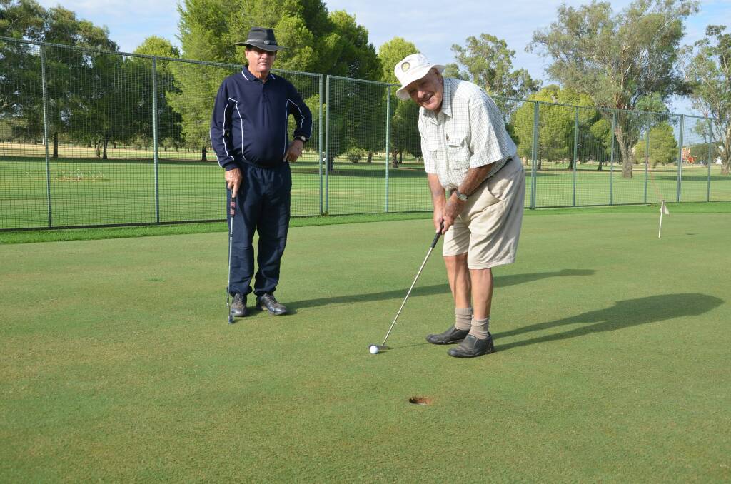 Perfect Putt: Barry Parker and Tom Edols putting on the practice green. 