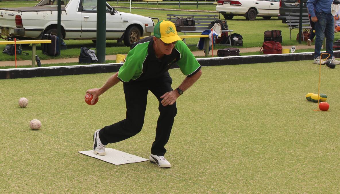 Dennis Byrnes sends a bowl down the green in a social game on Australia Day. 