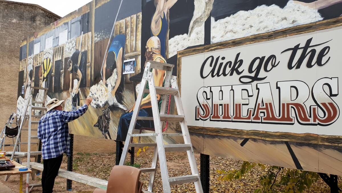 Artist Peter Crossman working on the Click Go The Shears mural in Eugowra. Photo by Tim Cheney.