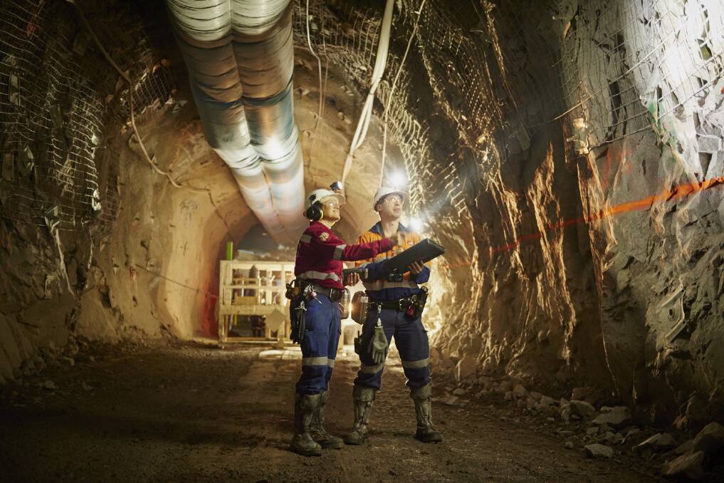 Underground Technical team members in the Northparkes E26 underground sub-level-cave mine. Photo supplied. 