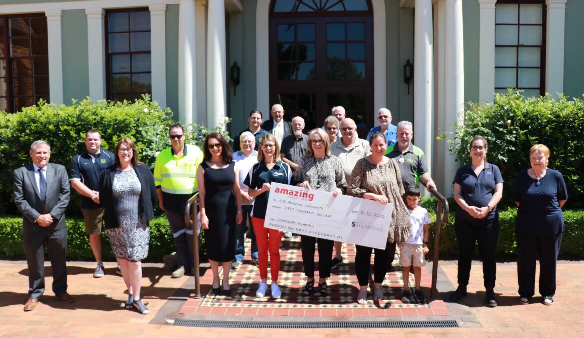 Forbes Mayor Phyllis Miller, councillors and council staff share out the first round of the 2020 community funding. Happily accepting the cheque on behalf of community groups are Kristy Wallace (left) and Candice and Ollie Iyer (right).