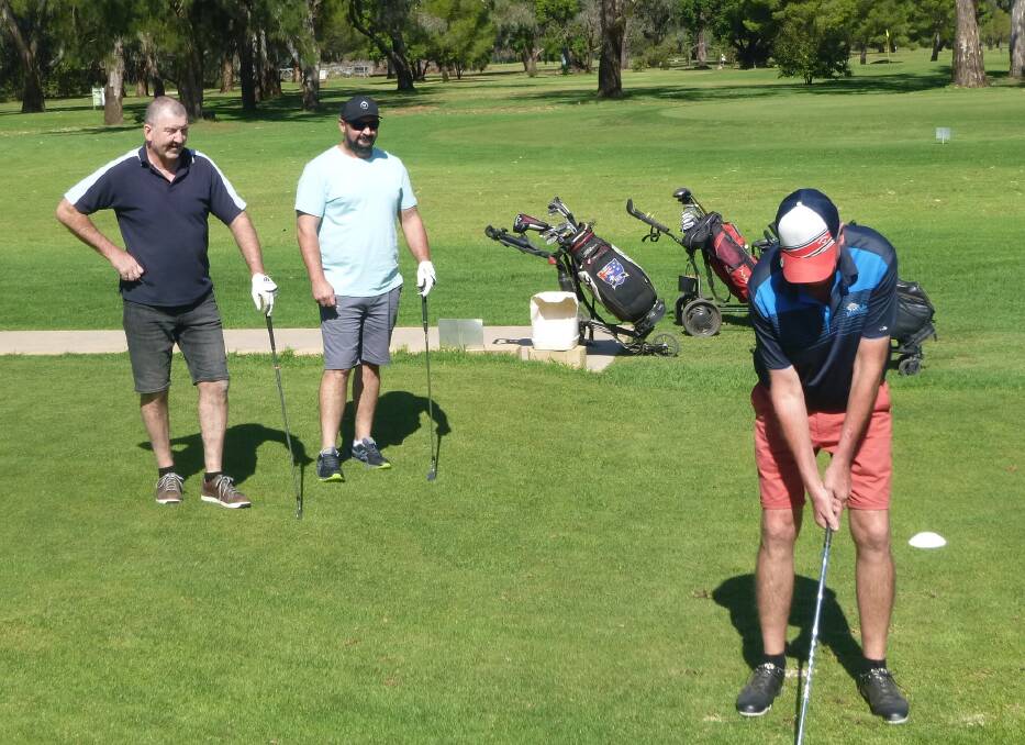 GREAT DAY FOR GOLF: Phil Maher readies to tee off, keenly watched by his group as they are all bathed in sunshine. Picture: SUPPLIED