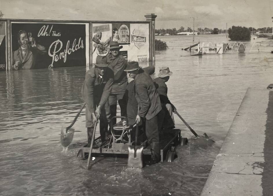 In this picture found at the Advocate office, fettlers at work to clear debris from the rail line adjacent to the Forbes railway station in June 1952 flooding. 
