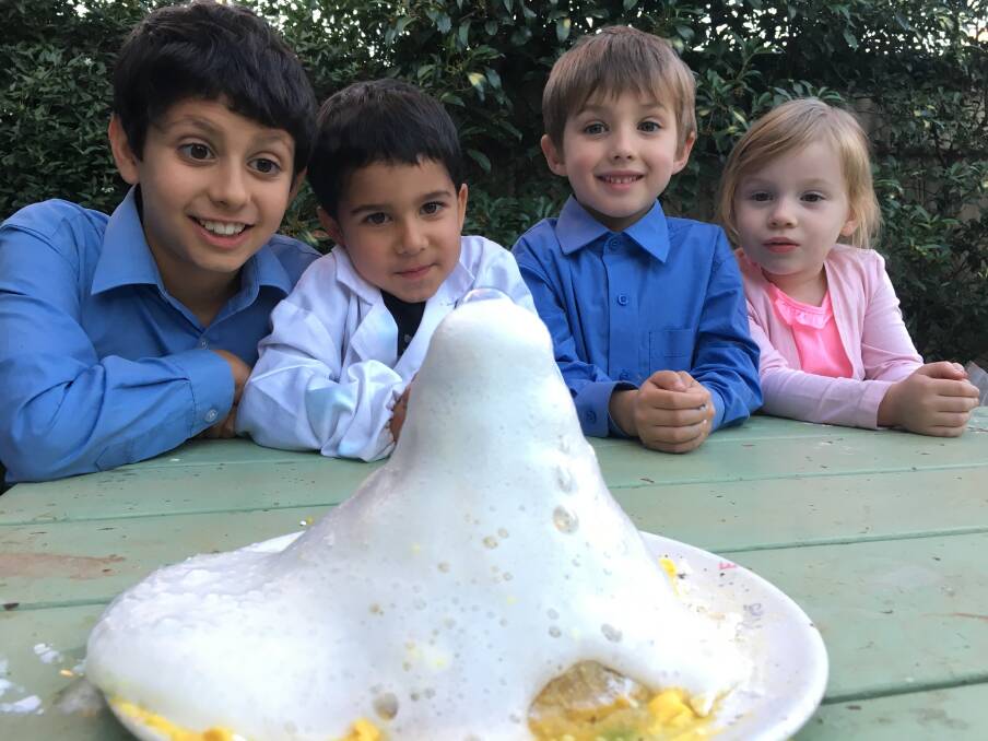 Lenny and Ollie Iyer and Cooper and Charlotte Miller get ready for the first Forbes Science Discovery Day by making their own volcano. 