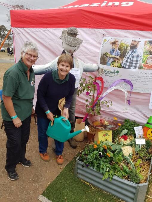 Heather Moore and Nina Crawford encouraging entries in this year's Riverside Community Gardens vegetable garden and scarecrow competitions.