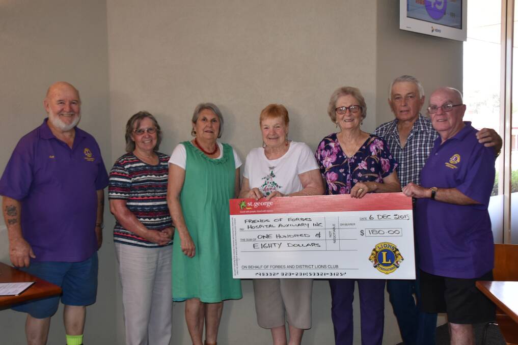 Lions Ray Judge (left) and Ian Gilchrist (right) present Friends of Forbes Hospital auxiliary members Robyn Kenny, Jean Hodges, Wilma Hepburn, Gloria Haley, Norm Haley with a cheque for the proceeds from the car boot sale.