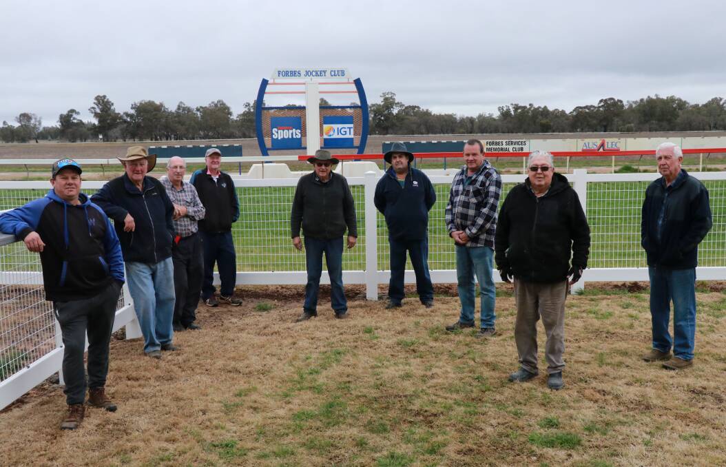 Forbes Jockey Club volunteers took a break from a chilly Sunday working bee for a photo and a look at the running rail.