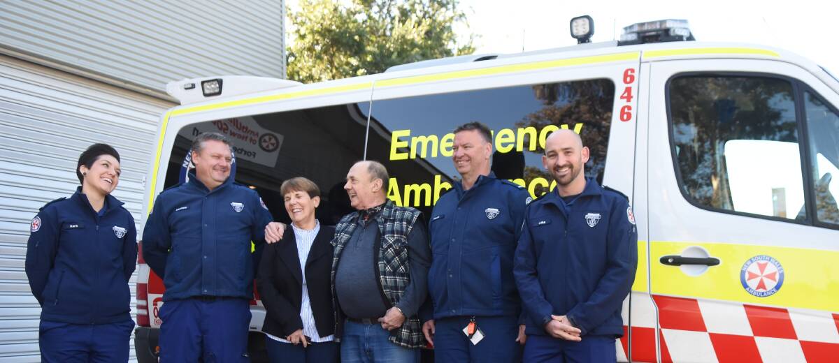 Lionel Huggett and his wife Diane with ambulance officers Kara West, Matthew White, Kevin Watts and Luke Randall all smiles a few months on from Lionel's heart attack.