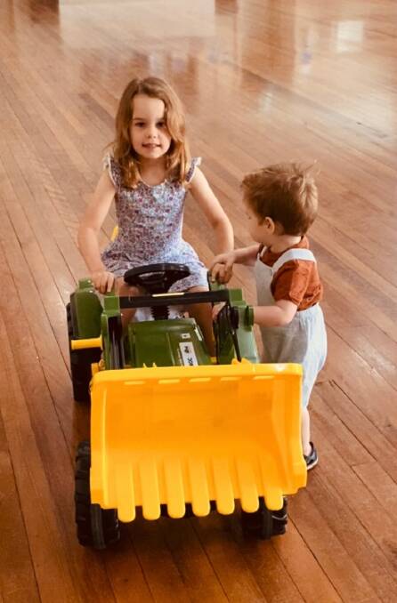 Forbes Toy Library members Isabel and Harry Teale check out the new John Deere Tractor recently purchased by the Toy Library using funding from the 2021 Northparkes Community Investment Program.