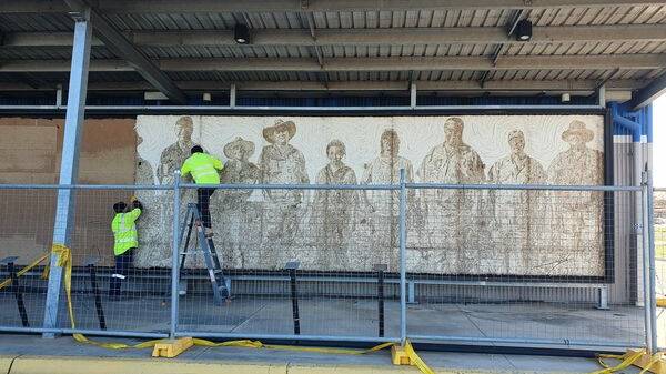 PREPARATION: Local builders and glaziers worked with Forbes Shire Council to remove the wool mural designed by Rosie Johnston from the former Spotlight store on Wednesday. Picture: FORBES SHIRE COUNCIL FACEBOOK