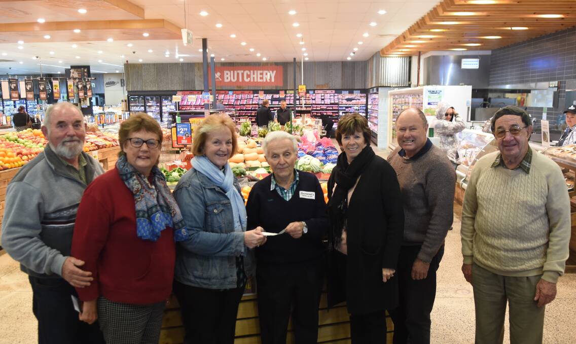 Nell's Pantry representatives Noel and Sue Jollife, Rev Crystal Spindler, Caroline and Geoff Wells and Rex Toole thank Tony Bernardi (centre) for his donation.