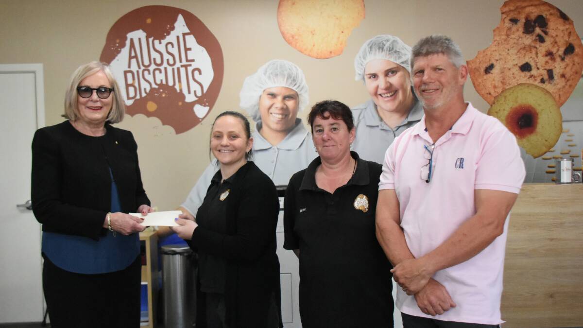 Business Enterprise Centre board members Mayor Phyllis Miller and Cr Jeff Nicholson present the funds to Aussie Biscuits' Tish Humphries and Shirley Stonham. 