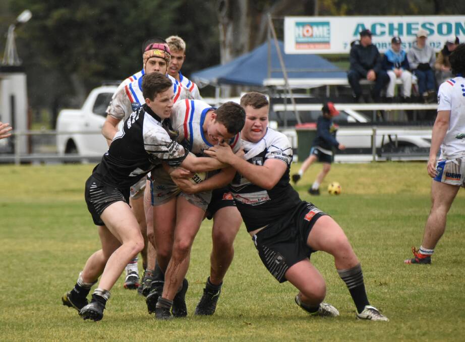 Connor Greenhalgh and Tom Phillips work to bring the Spacemen down at Spooner Oval when Forbes and Parkes last met. 