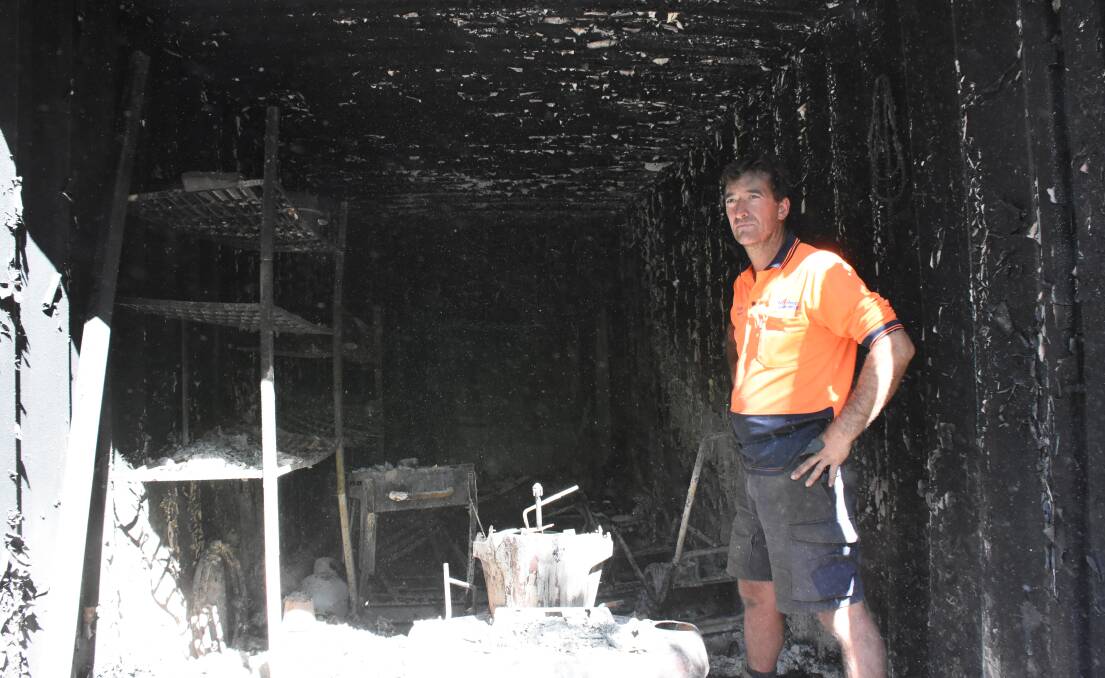 Scott Johnston inspects the burnt-out contents of the archery club's container.