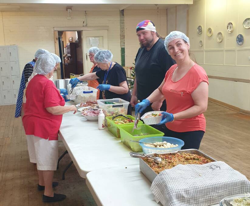 Volunteers hard at working serving Christmas dinner through Havannah House's annual effort. 