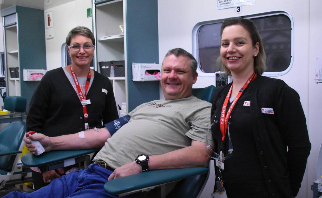 Red Cross Blood Service's Tanya Warren and Liesa Pansini with Forbes' Matt White who made his 25th donation on Monday.